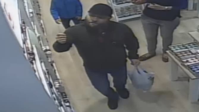 CCTV released and video after a man used a young boy as part of a distraction theft