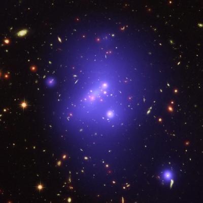 epa05091929 A handout picture relased by the NASA on 07 January 2016 of galaxy cluster, called IDCS J1426.5+3508 (IDCS 1426 for short), in X-rays from the Chandra X-ray Observatory in blue, visible light from the Hubble Space Telescope in green, and infrared light from the Spitzer Space Telescope in red. This rare galaxy cluster, which is located 10 billion light years from Earth, weighs almost 500 trillion Suns. This object has important implications for understanding how these mega-structures formed and evolved early in the Universe. Astronomers have observed IDCS 1426 when the universe was less than a third of its current age. It is the most massive galaxy cluster detected at such an early age.  EPA/CHANDRA X-RAY OBSERVATORY CENTER / HANDOUT  HANDOUT EDITORIAL USE ONLY