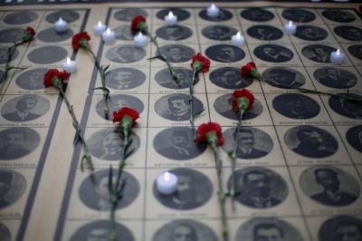 epa05275888 Candles burn on pictures of killed Armenian people during a protest at the tunnel square to mark the 101st anniversary of the mass killing of Armenians in the Ottoman Empire in 1915, in Istanbul, Turkey, 24 April 2016. The total death toll is estimated to between 800,000 and 1.5 millions.  EPA/CEM TURKEL