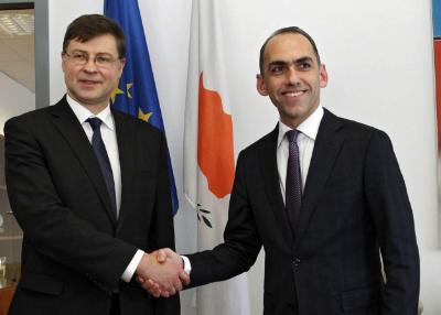 epa05192619 Cypriot Minister of Finance Harris Georgiades (R) shakes hands with European Commission Vice-President in charge of the Euro and Social Dialogue Valdis Dombrovskis (L), at the Cypriot Finance Ministry in Nicosia, Cyprus, 03 March 2016. Dombrovskis is on one-day visit to Cyprus.  EPA/KATIA CHRISTODOULOU