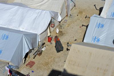 epa05140134 A Syrian refugee woman walks outside her makeshift shelter at Barr Elias Syrian refugee camp in the Bekaa valley, eastern Lebanon, 02 February 2016. UNHCR estimates over 1.5 million Syrian refugees are currently living in Lebanon.  EPA/WAEL HAMZEH