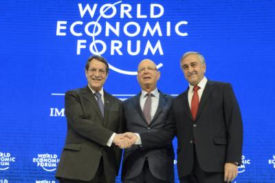 epa05115671 Nicos Anastasiades, (L), President of Cyprus shakes hands with Turkish Cypriot Leader Mustafa Akinci, (R), in front of German Klaus Schwab, (C), founder and president of the World Economic Forum, WEF, during a panel session during the 46th Annual Meeting of the World Economic Forum, WEF, in Davos, Switzerland, 21 January 2016. The overarching theme of the Meeting, which takes place from 20 to 23 January, is 'Mastering the Fourth Industrial Revolution.'  EPA/LAURENT GILLIERON