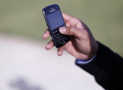 epa04027284 A man uses his Blackberry mobile device to write a text message in Atlanta, Georgia, USA, 17 January 2014. According to news reports citing top secret documents, the National Security Agency (NSA) allegedly collects some 200 million text messages and other personal data from mobile phones around the globe every day under an NSA program codenamed 'Dishfire'.  EPA/ERIK S. LESSER