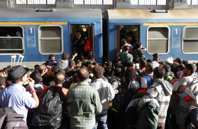 Migrants leave Budapest for Austrian frontier; pressure builds for EU action