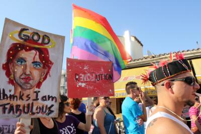 epa04786450 Participants hold signs during the second Cyprus Pride parade in central Nicosia, Cyprus, 06 June 2015. The parade was held as part of the LGBT (lesbian, gay, bisexual and transgender) community's second Gay Pride Festival in the country.  EPA/KATIA CHRISTODOULOU