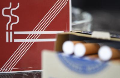 epa04698605 An archive picture made available on 10 April 2015 of a package of cigarettes liyng in front of a non-smoking sign at a cafe in Vienna, Austria, 07 January 2015. Austrian restaurants and bars will become smoke-free in 2018, the government announced 10 April 2015 arguing that it was time to bring non-smoking rules in line with the European mainstream. 
Owing to opposition from restaurant owners, there is only a partial smoking ban in Austria, which allows locales to set aside smoking rooms and includes exemptions for very small venues.  EPA/HELMUT FOHRINGER