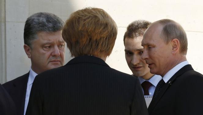 Putin, Ukraine leader break crisis ice at D-Day event