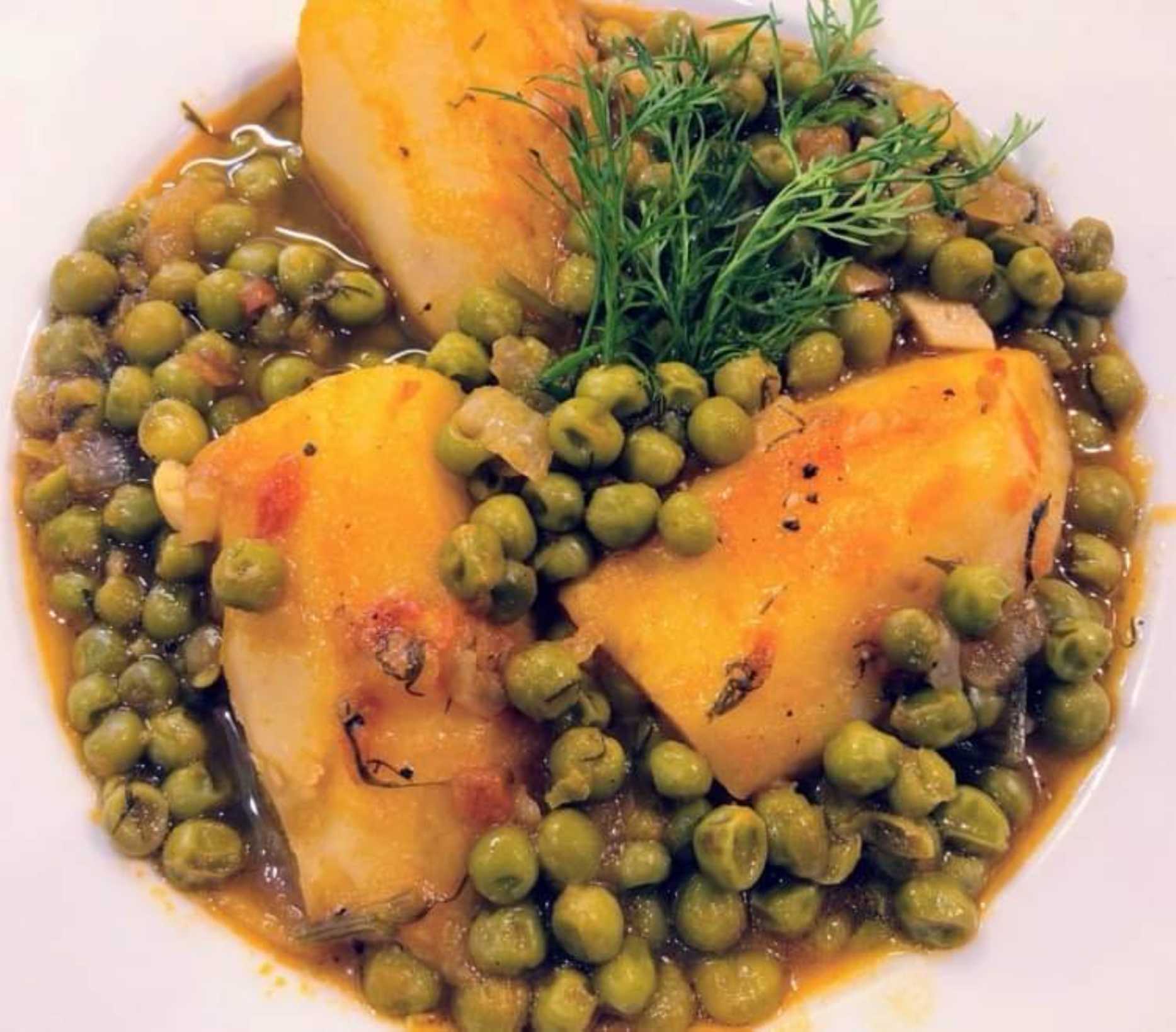 UK Cypriot celebrity chef Loulla Astin is cooking Αρακάς Γιαχνί / Peas and Potatoes in a tomato sauce