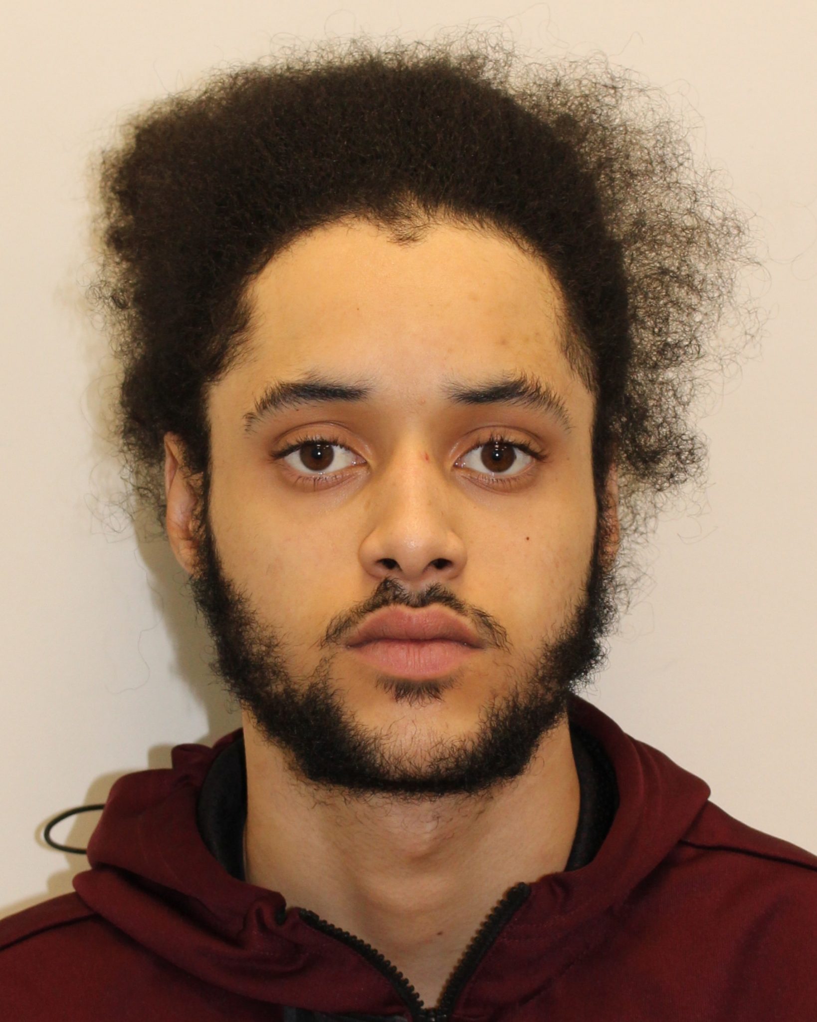 A man has been jailed for firearms offences after officers chased him down when they spotted a suspicious car