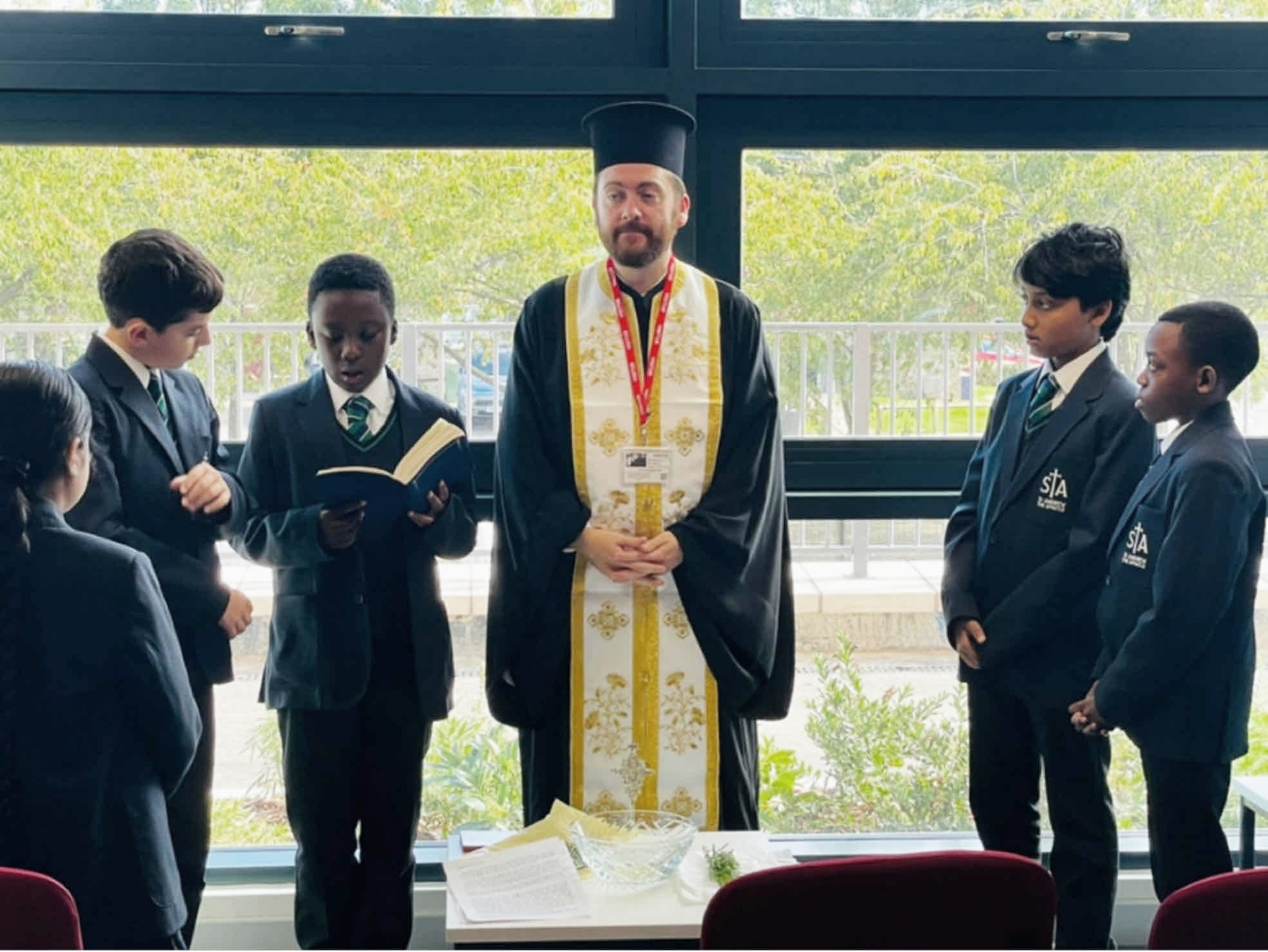 Father Gregory visits St Andrew the Apostle School to celebrate the Exaltation of the Holy Cross